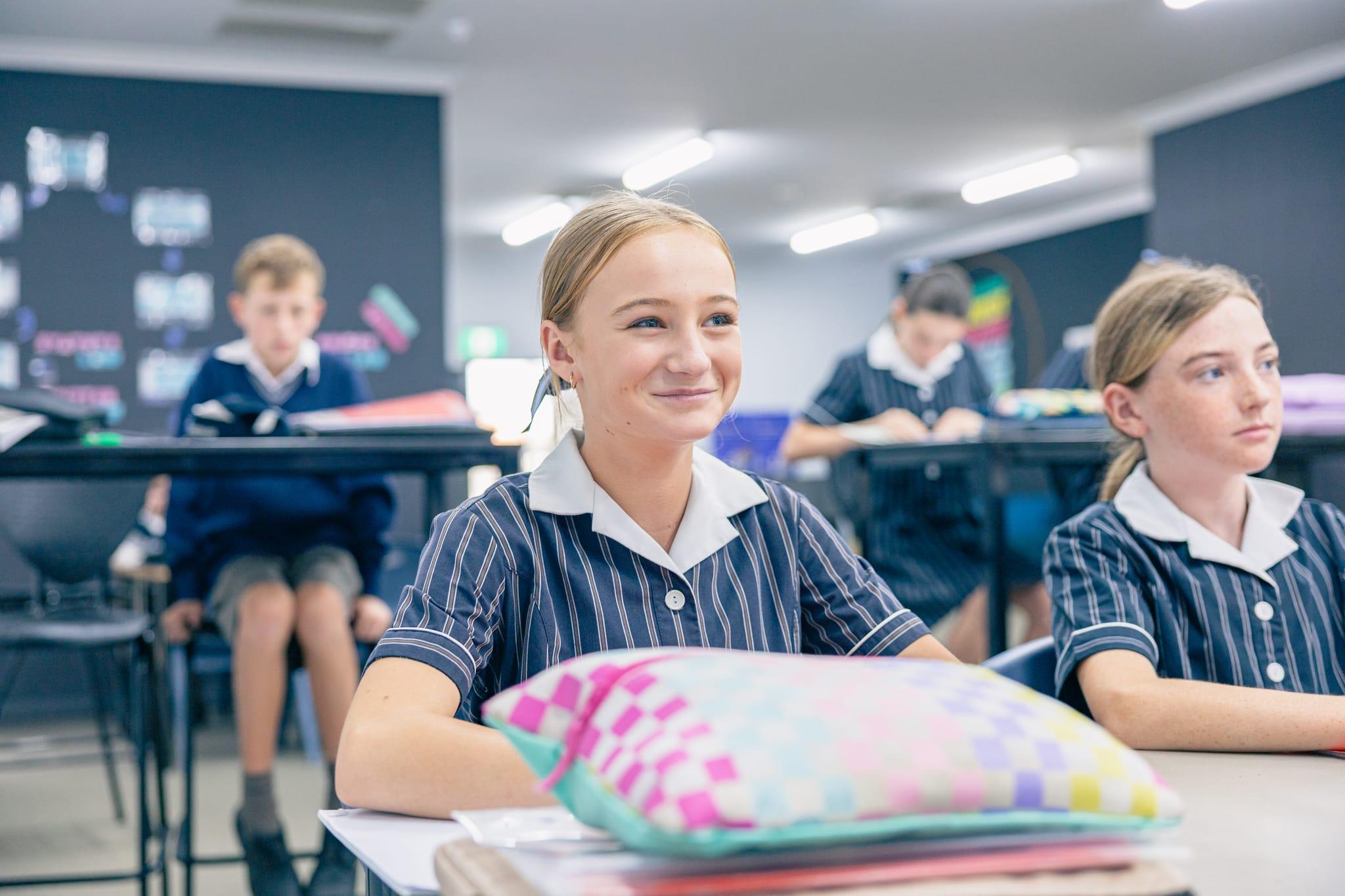 ACC Singleton middle school girls in a bright, structured classroom, engaged and confident as they learn through teacher-led, explicit instruction.