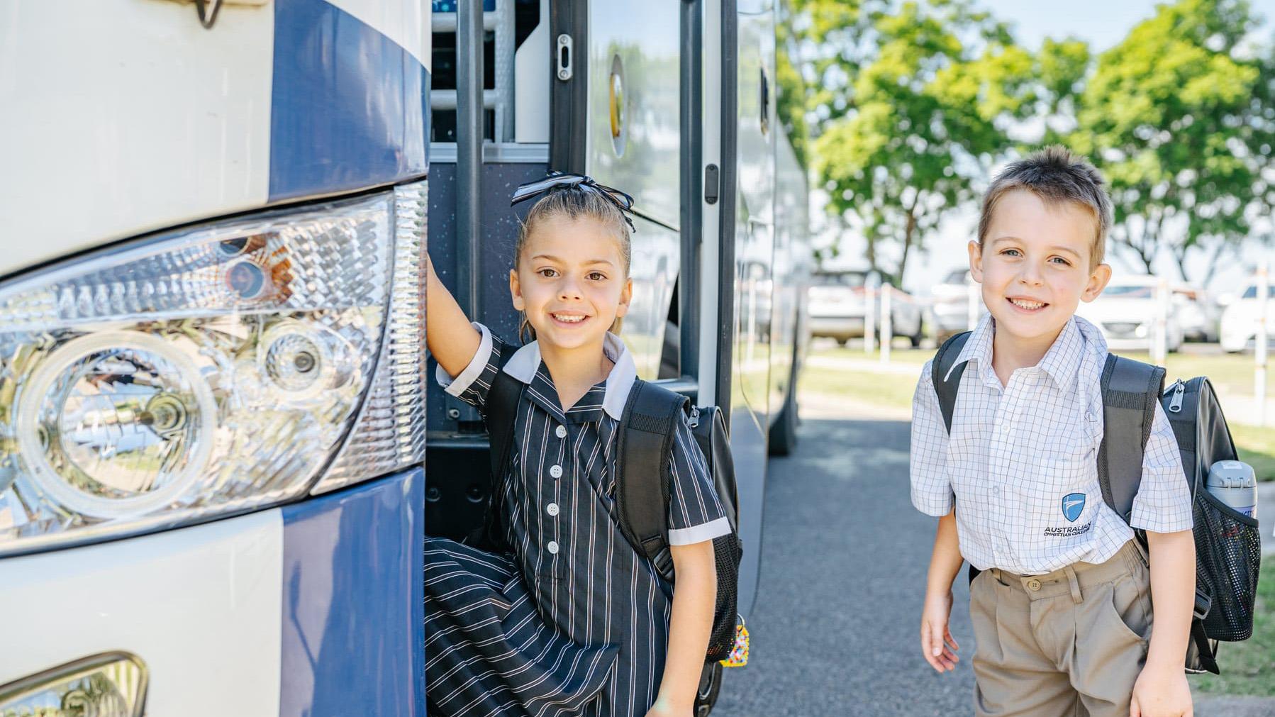 Junior school students smiling as they board a private school bus, showing safe and stress-free transport options at Australian Christian College Singleton.