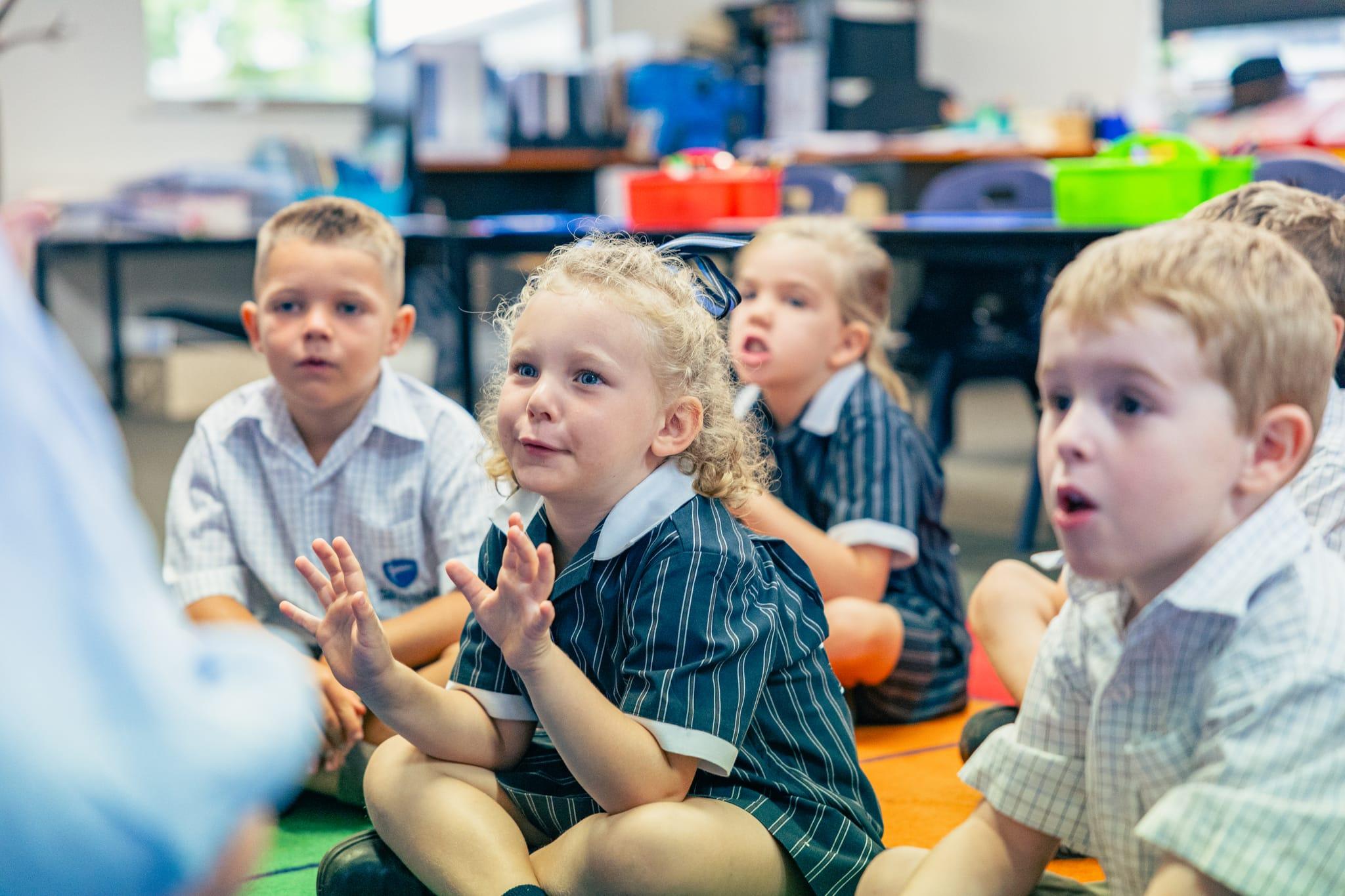 Junior students participating in an engaging group activity, responding enthusiastically during an interactive classroom session.