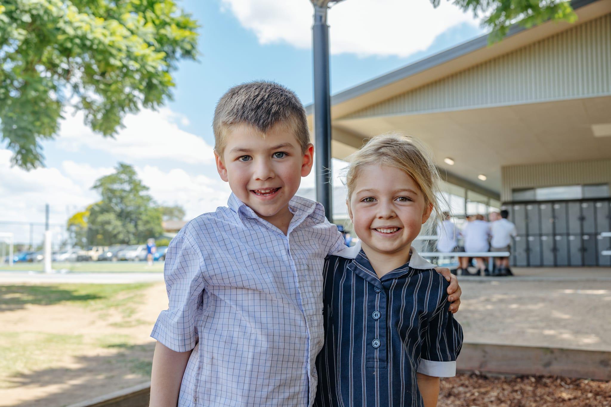 Happy junior students smiling outdoors at ACC Singleton, symbolising a warm and welcoming enrolment experience.