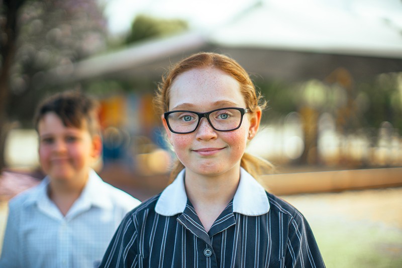 Smiling female student wearing glasses