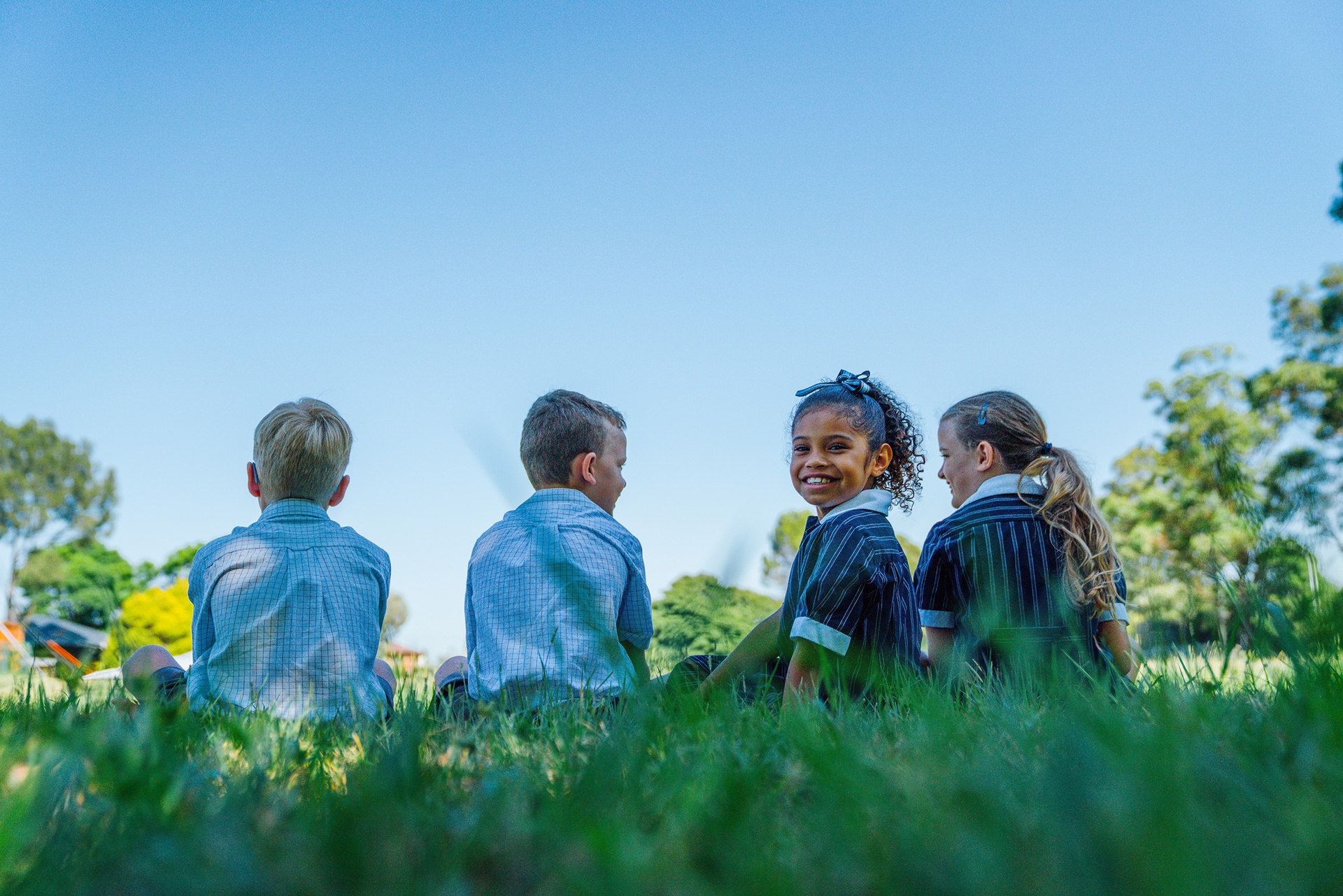 Australian Christian College Singleton Primary school students sitting on grass outside