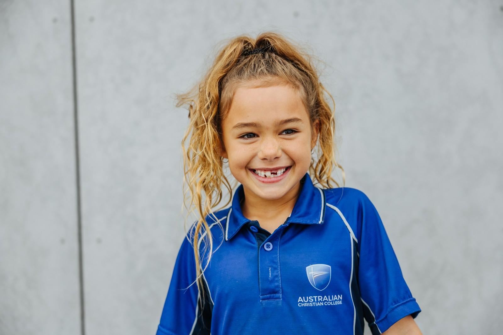 Smiling primary girl in ACC uniform at Albany school