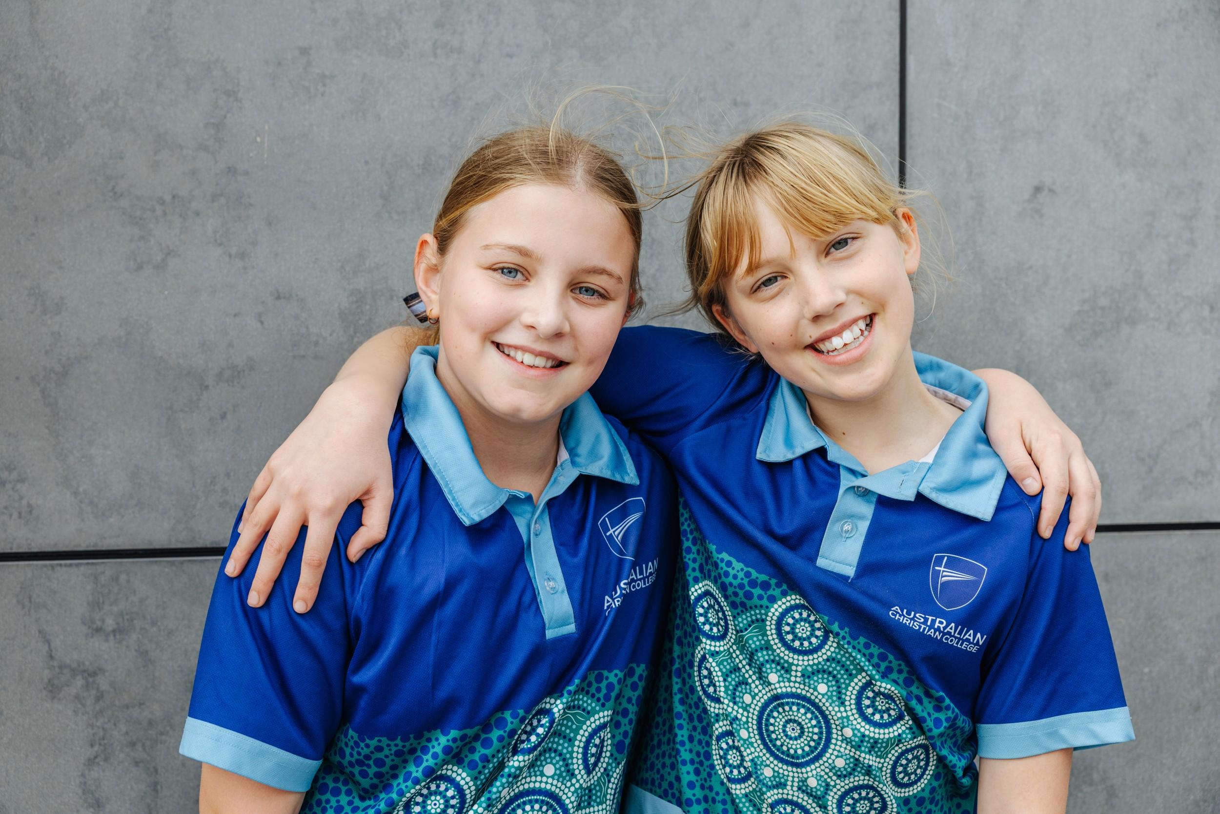 Two smiling Albany primary school girls in ACC sport uniform