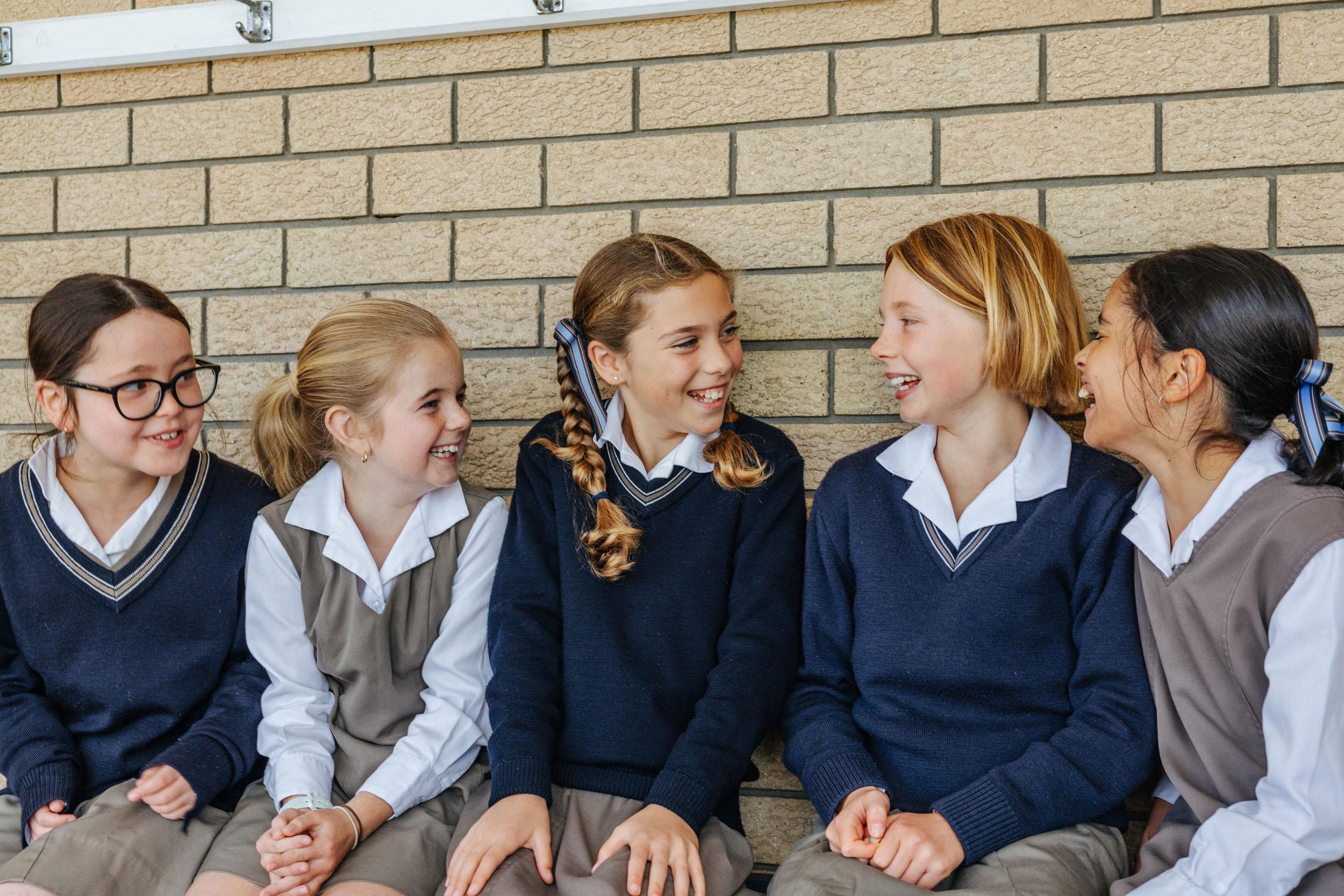 Primary girls chatting together on campus at ACC Southlands Albany