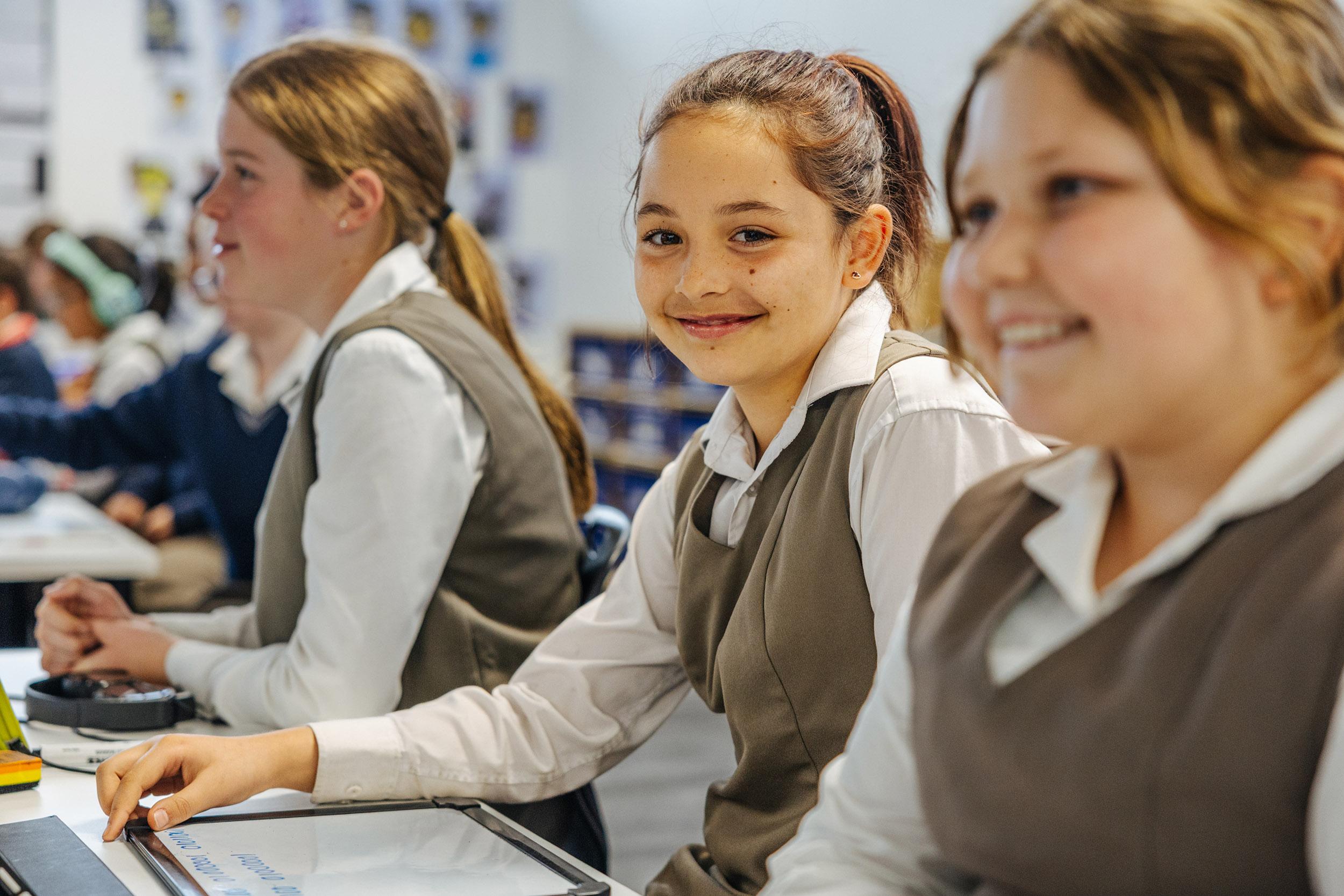 Three ACC Southlands students sitting together in classroom