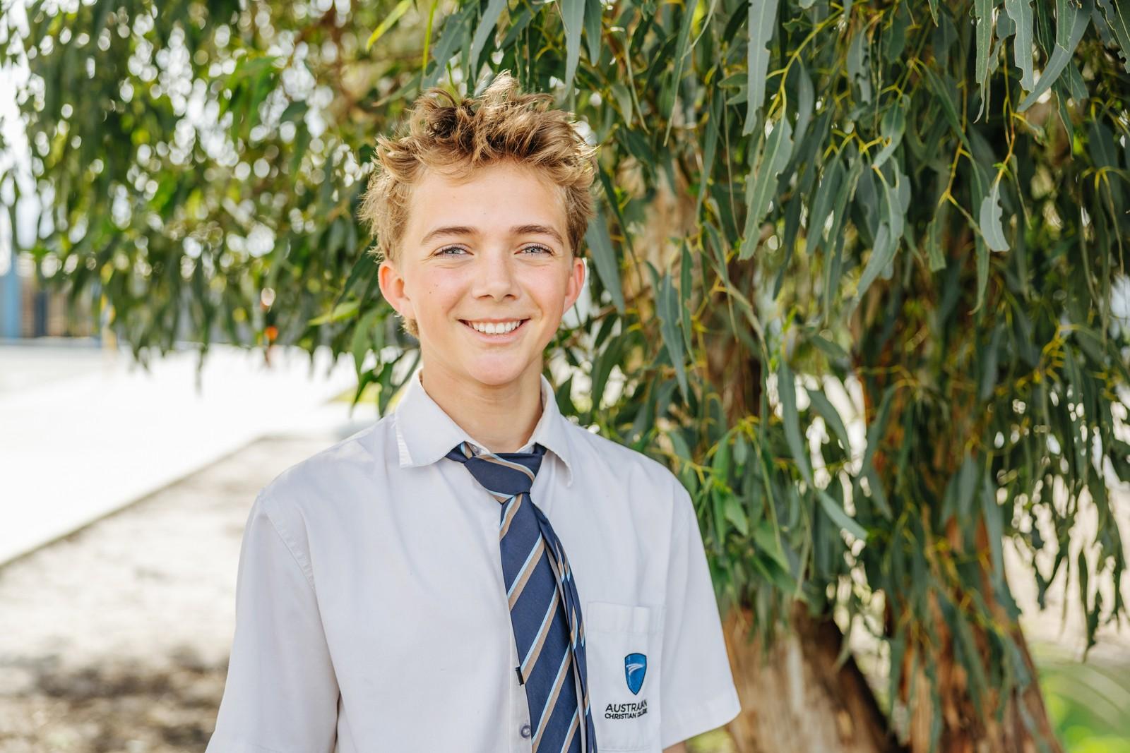 Smiling secondary school student in ACC uniform outdoors in Collingwood Heights