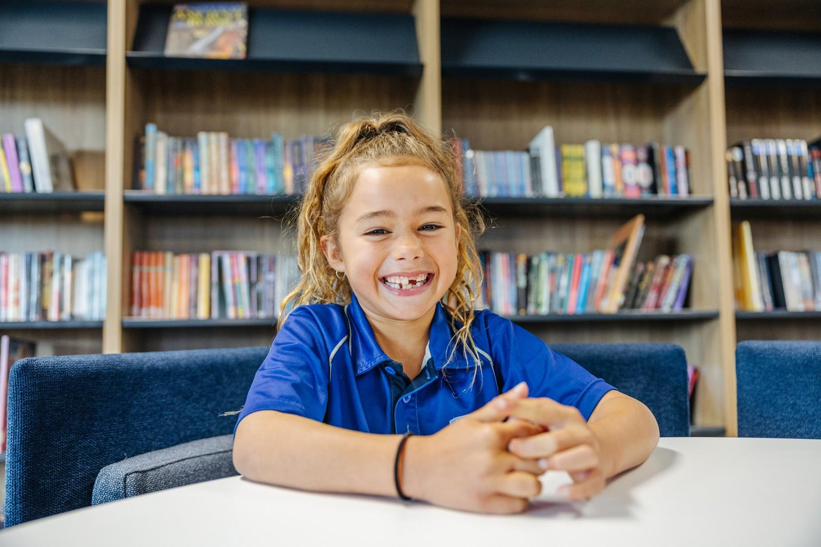 Smiling primary school student in the library at Collingwood Heights Christian school