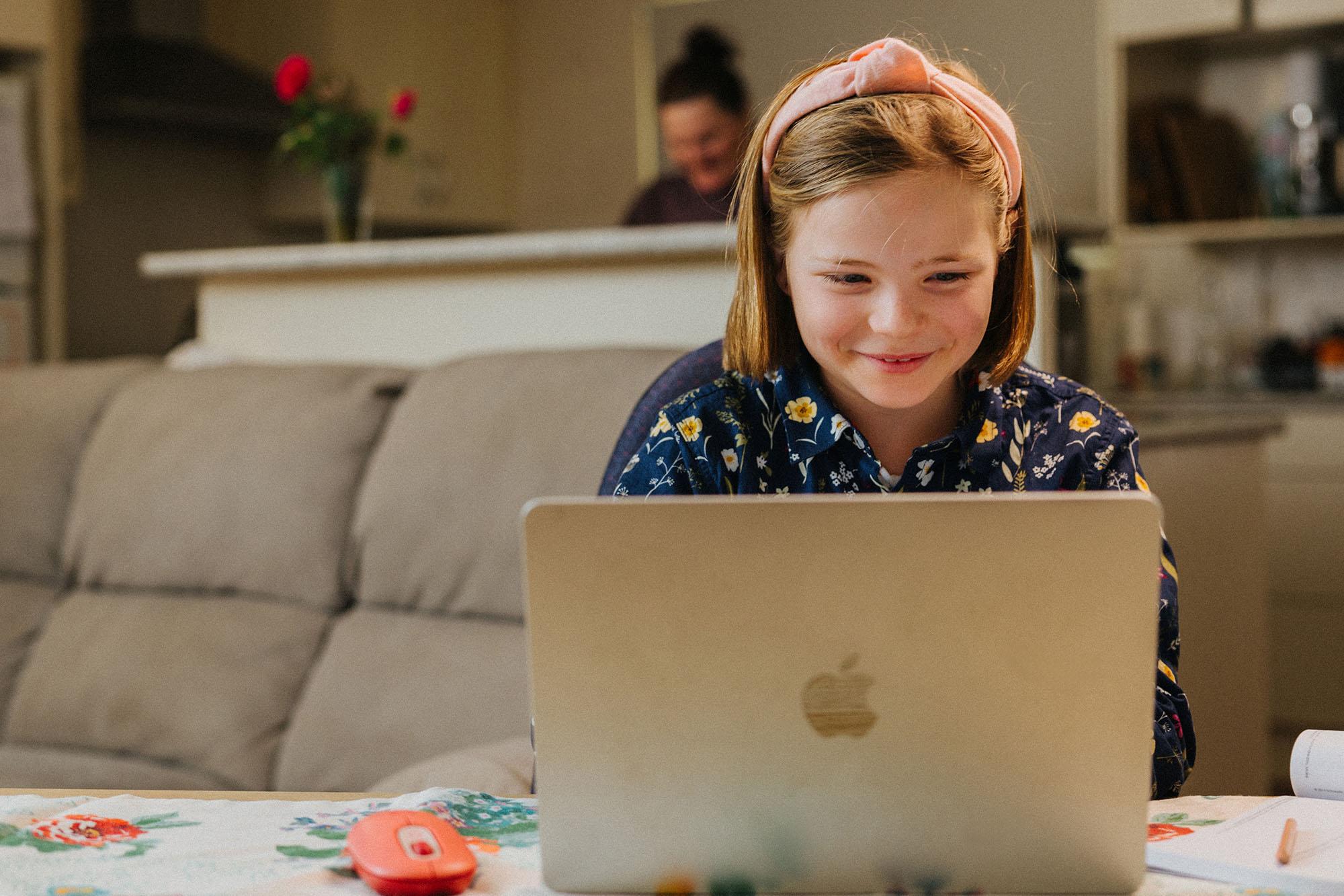 Student doing schoolwork from home on laptop
