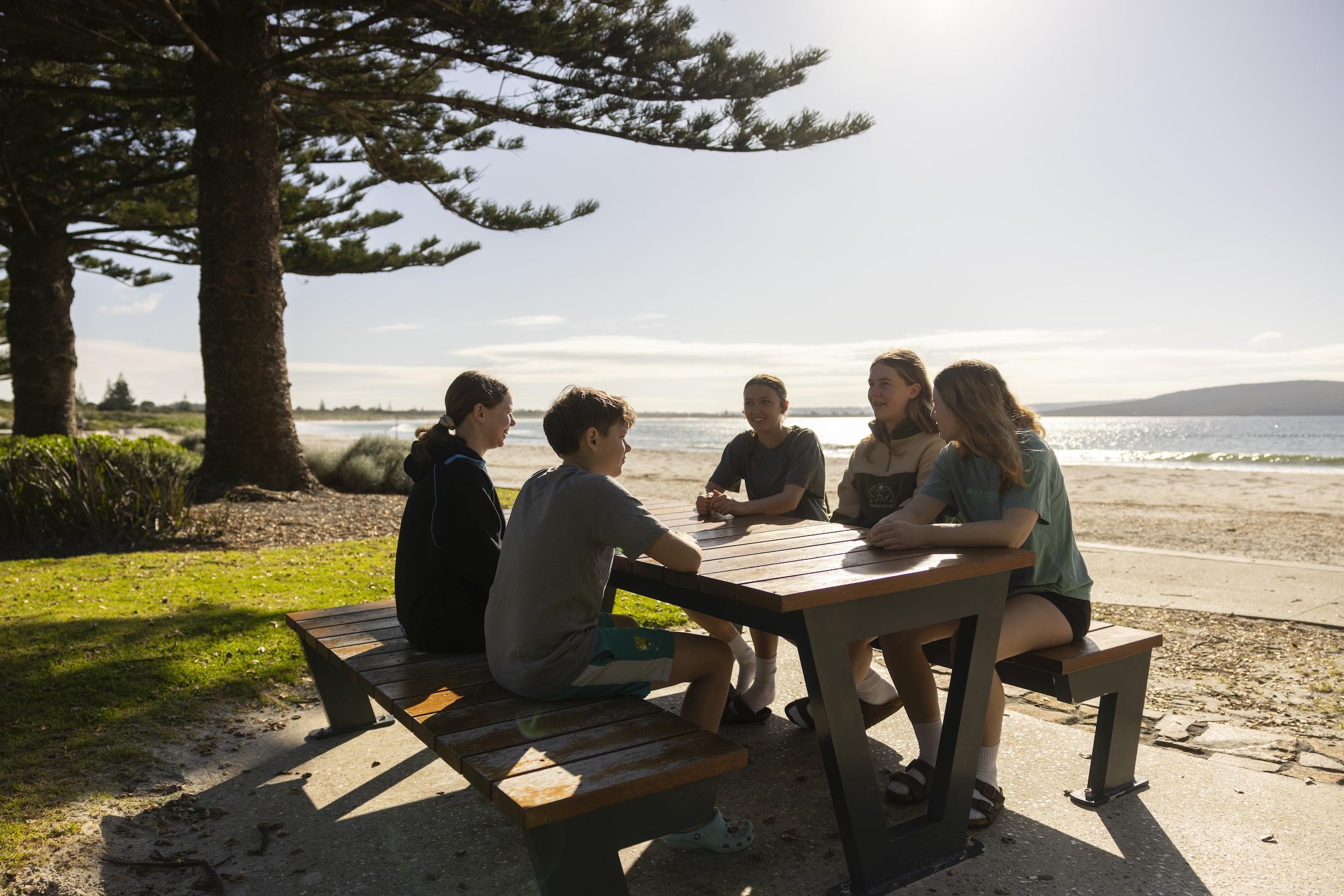 Students socialising outside by the lake