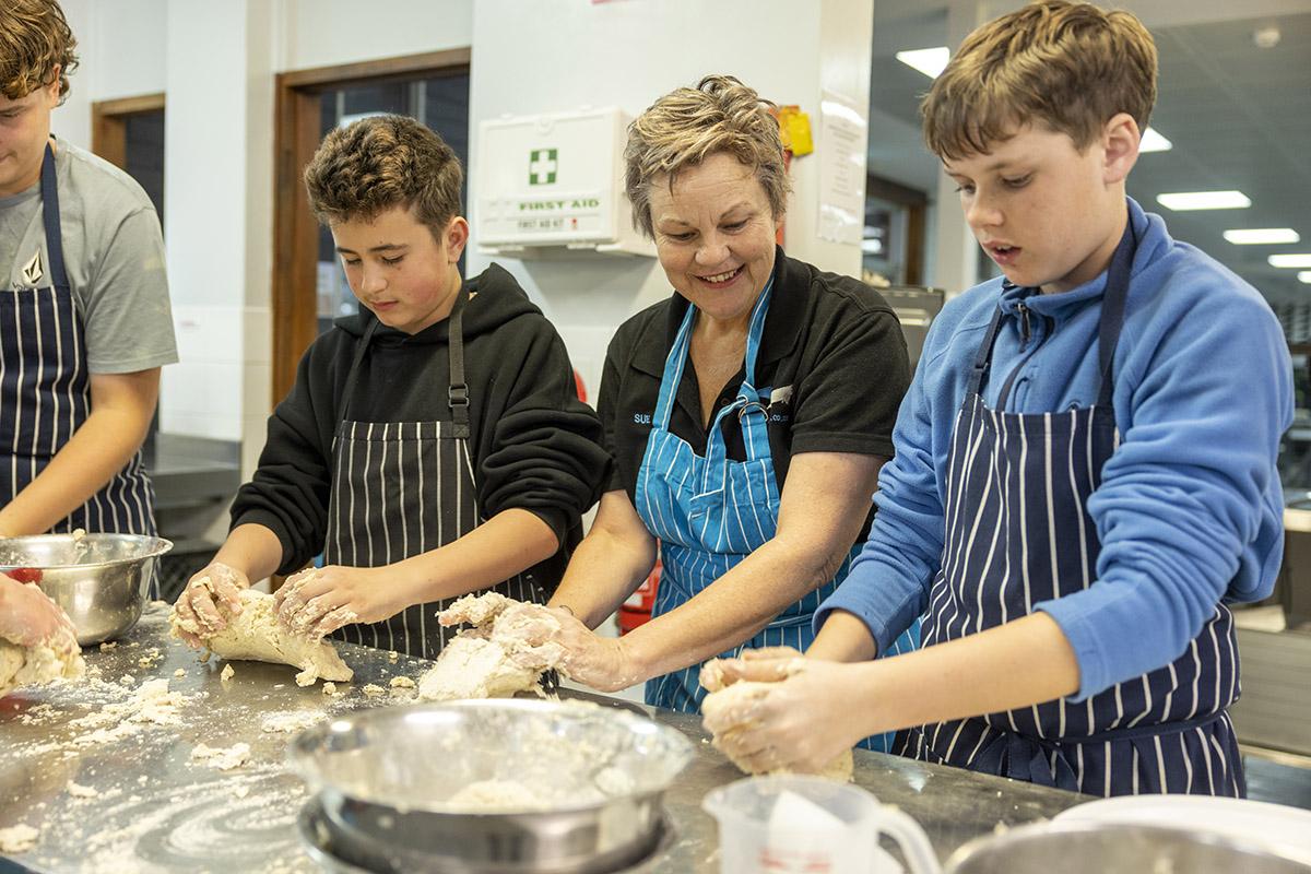 Students cooking in a commercial kitchen
