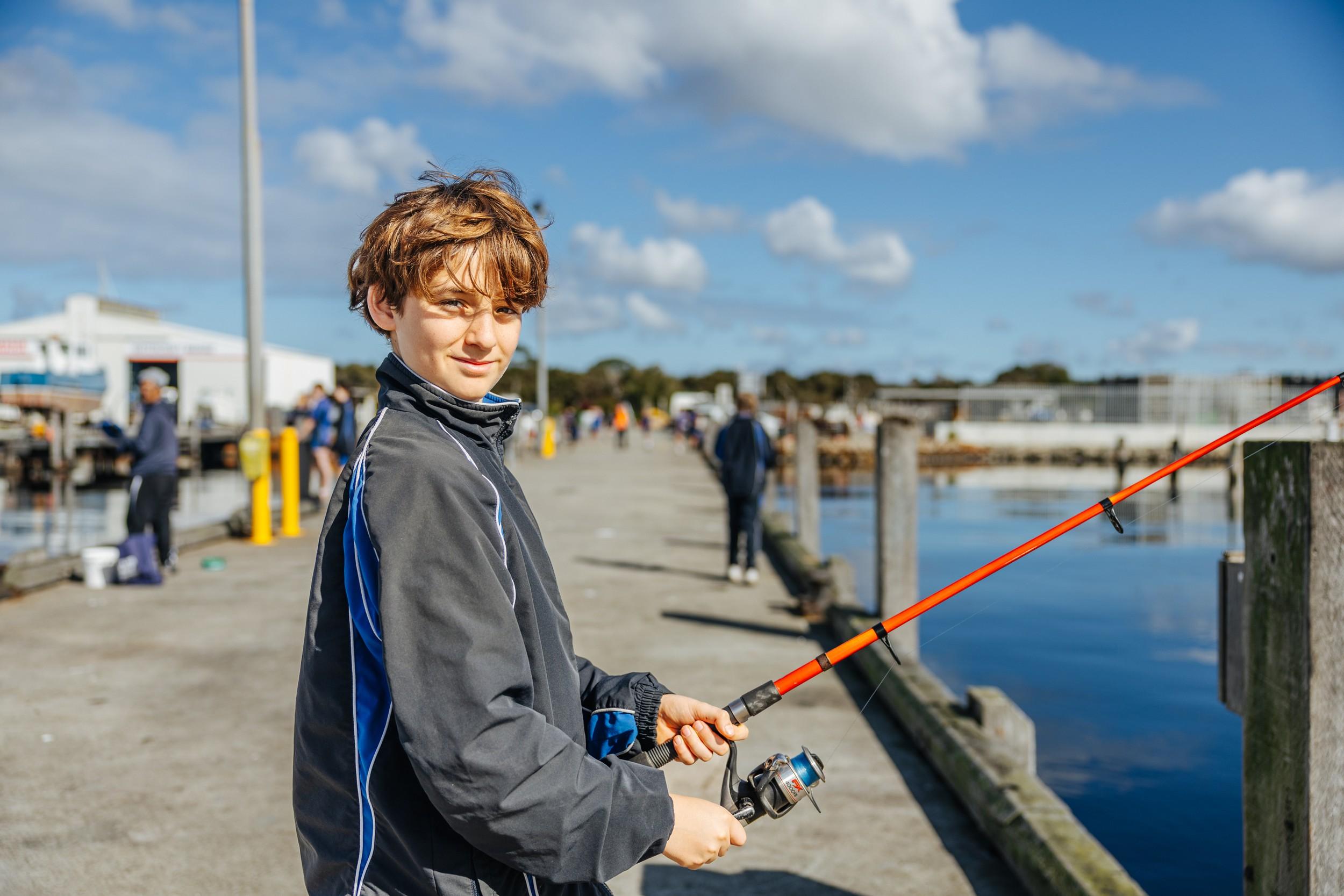 ACC Southlands student fishing from a jetty during a co-curricular outdoor activity