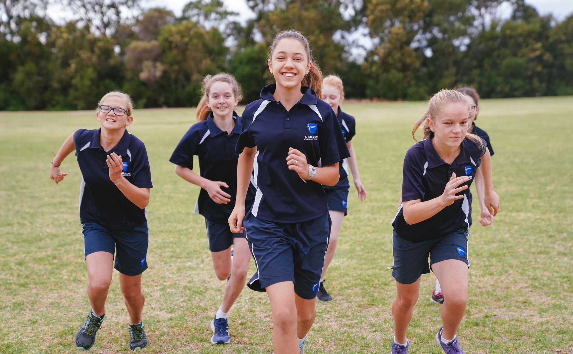 ACC Albany students in sports uniform running towards camera