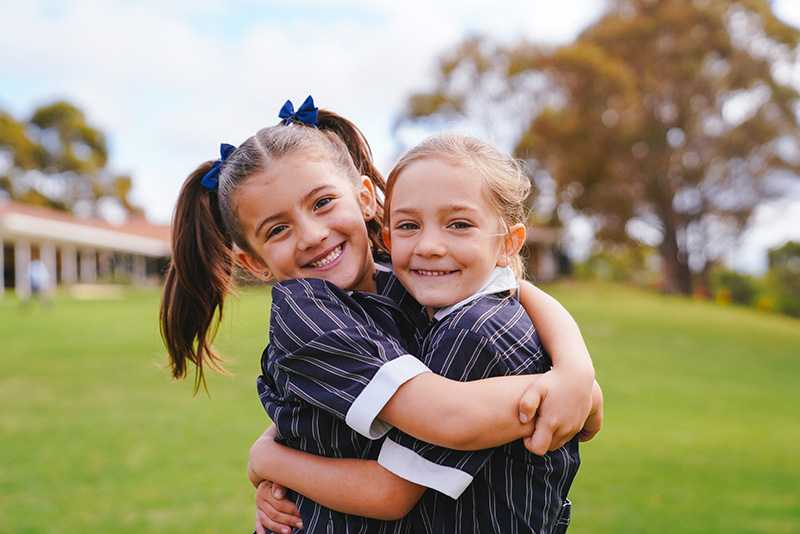 Primary students hugging