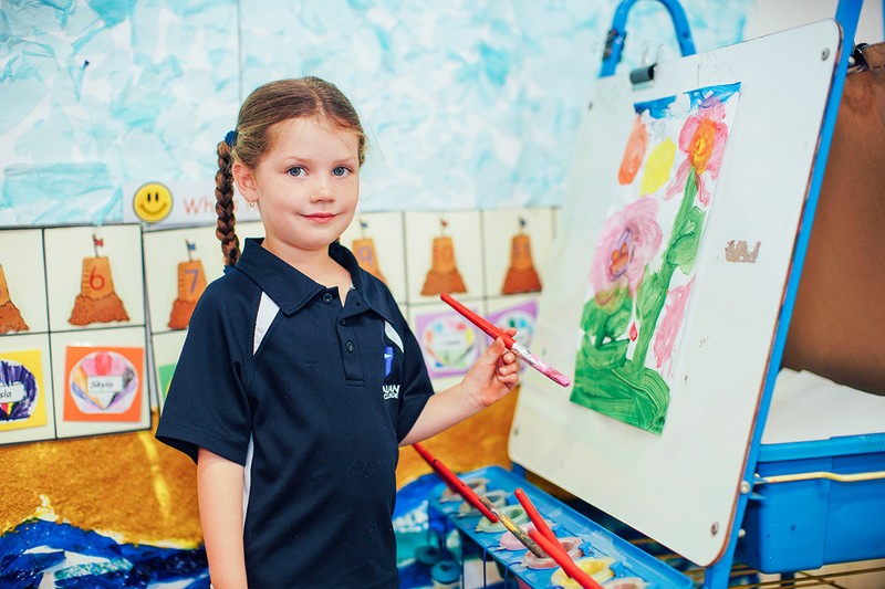 kindergarten girl painting picture of flowers