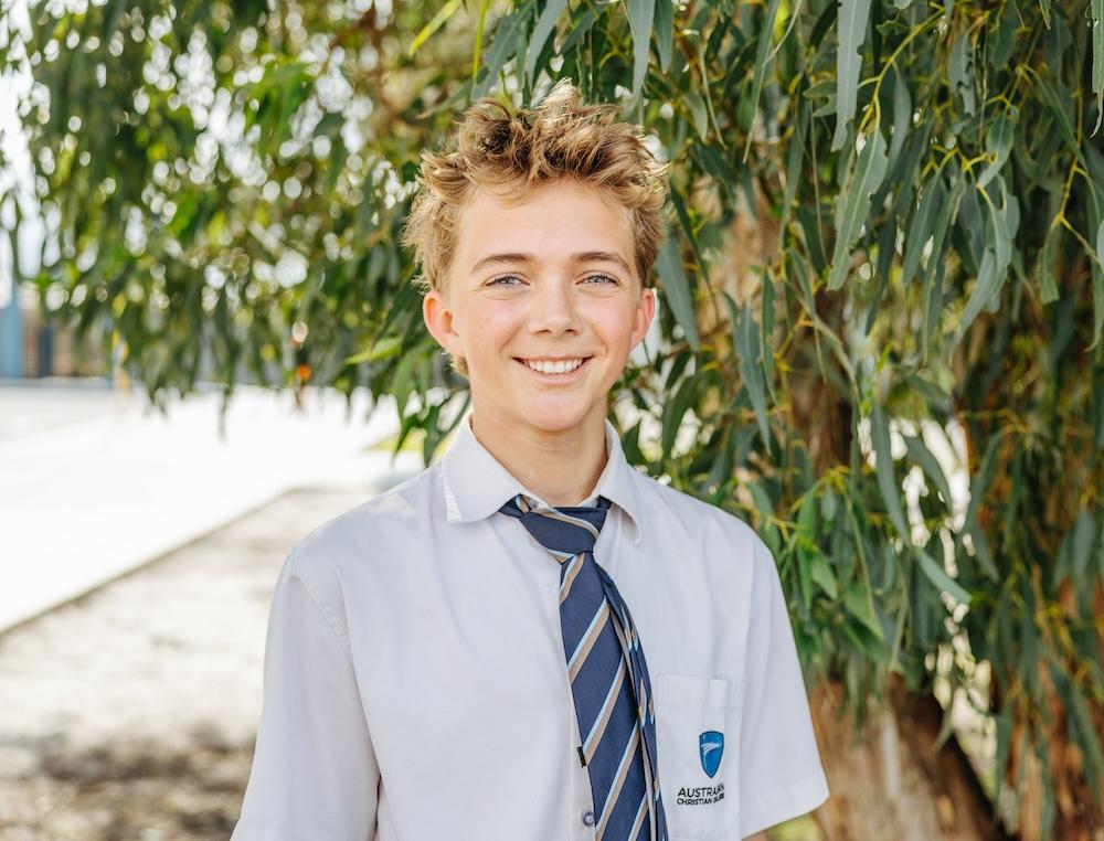 Student outside under a tree at ACC Swan Hill, reflecting the nurturing and supportive learning environment