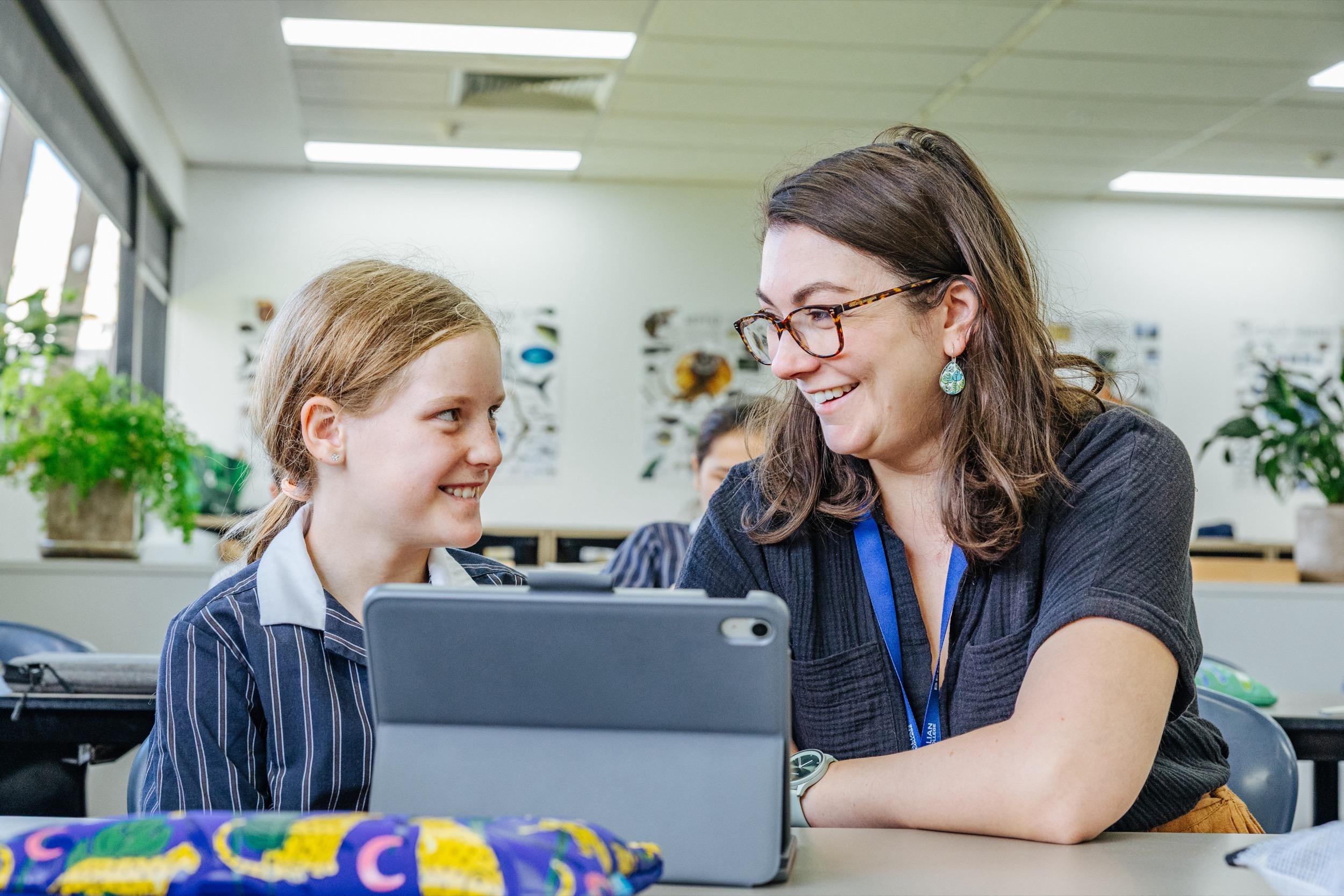 A teacher and a student at ACC Swan Hill engage in a discussion while looking at a tablet