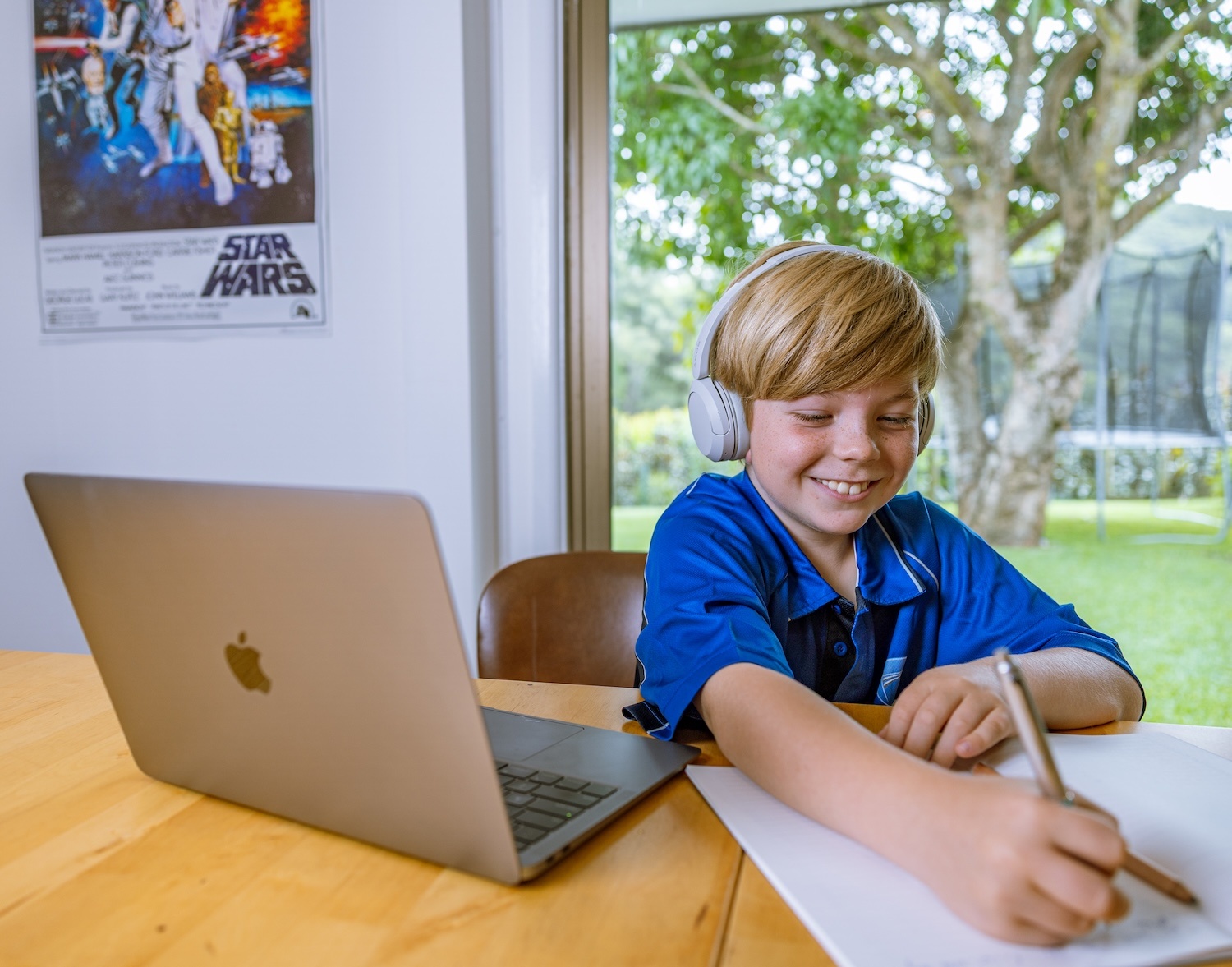 High School aged Victorian student studying on laptop outside