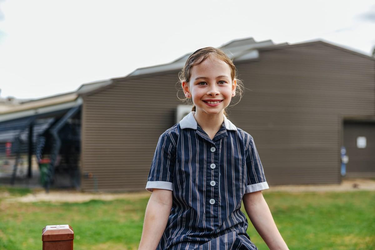 Student smiling outdoors at ACC Victoria campus